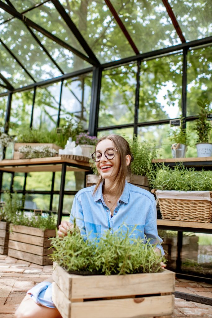 Woman with herbs in the greenhouse